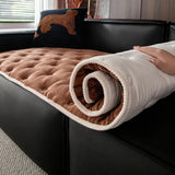 Quilted sofa cover with deep relief