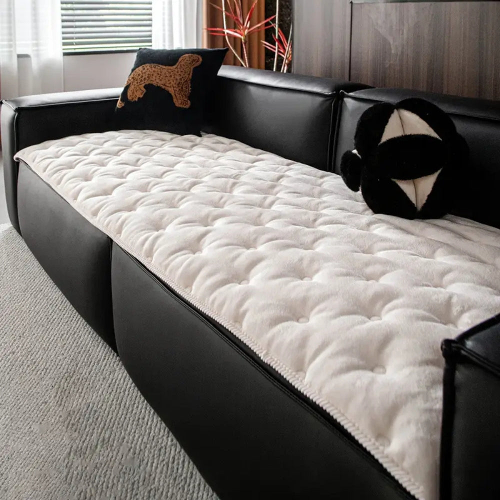 Quilted sofa cover with deep relief